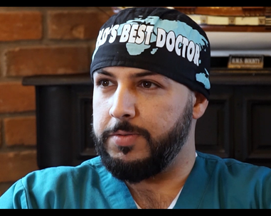 A man wearing a surgical cap and beard.