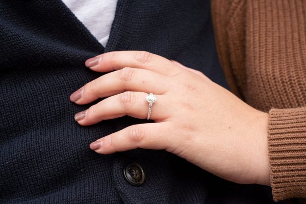 A woman wearing a ring on her finger.
