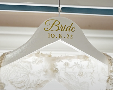 A bride 's hanger with the date of her wedding.